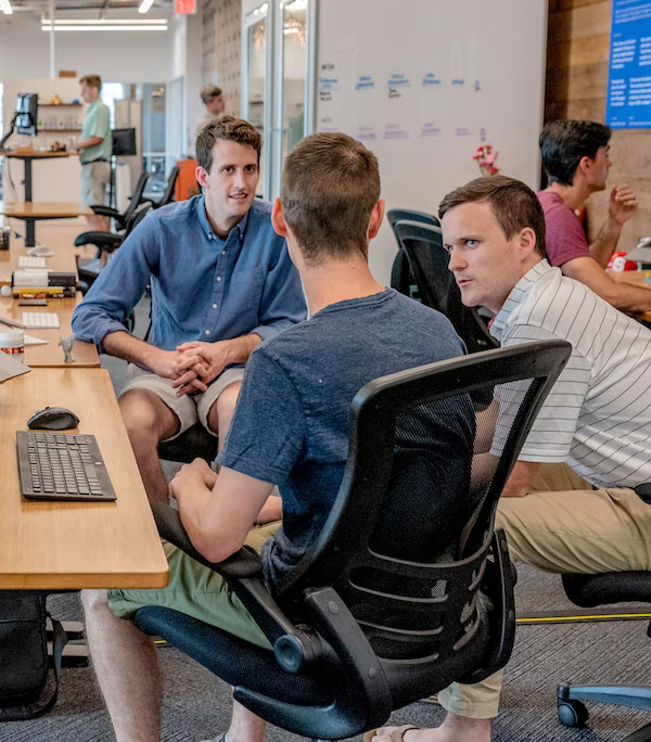 Team members collaborating and sharing ideas in a meeting for project planning